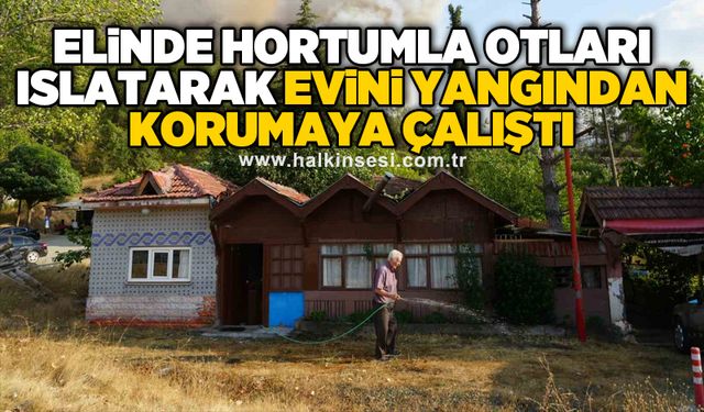 Elinde hortumla otları ıslatarak evini yangından korumaya çalıştı